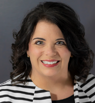 Professional headshot of Lisa Flanders-Dick. She is a white female will dark brown hair. She is wearing a black and white striped blazer and smiling.